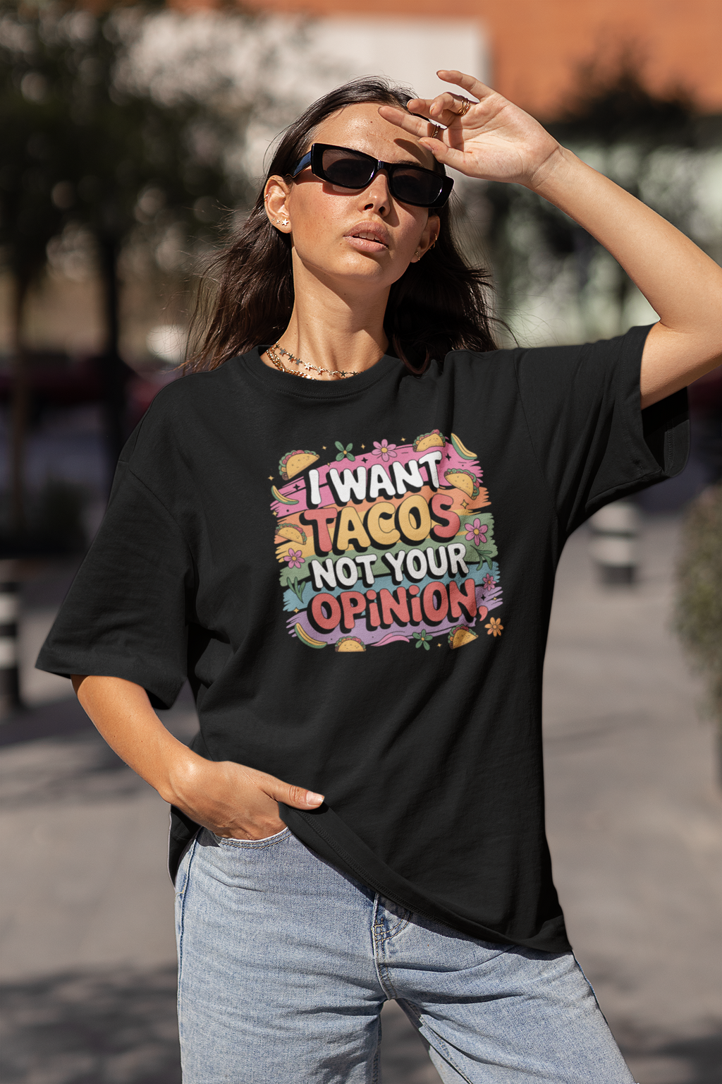 Woman wearing a black t-shirt with colorful text outdoors