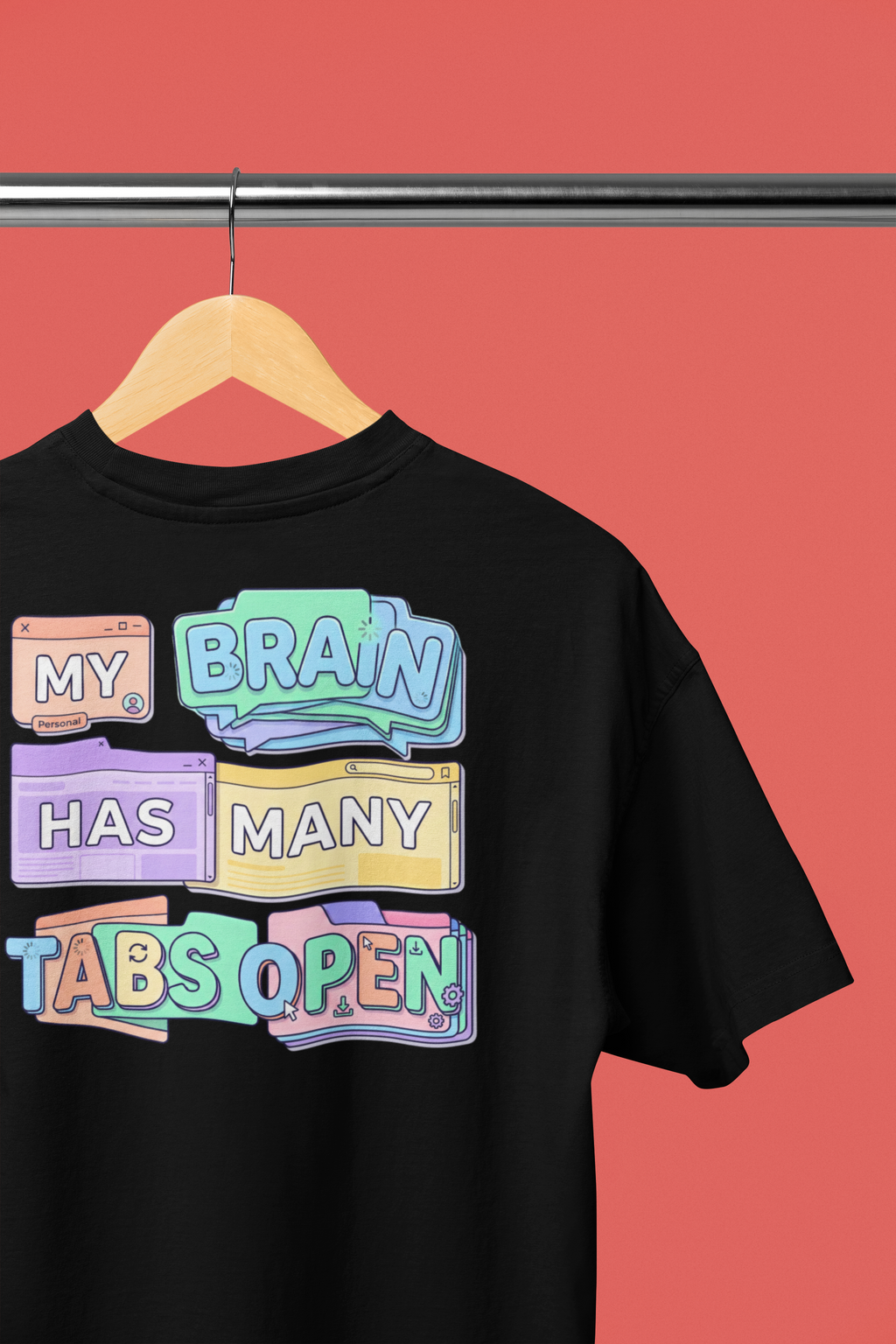 Black t-shirt with colorful text design on a hanger against a red background