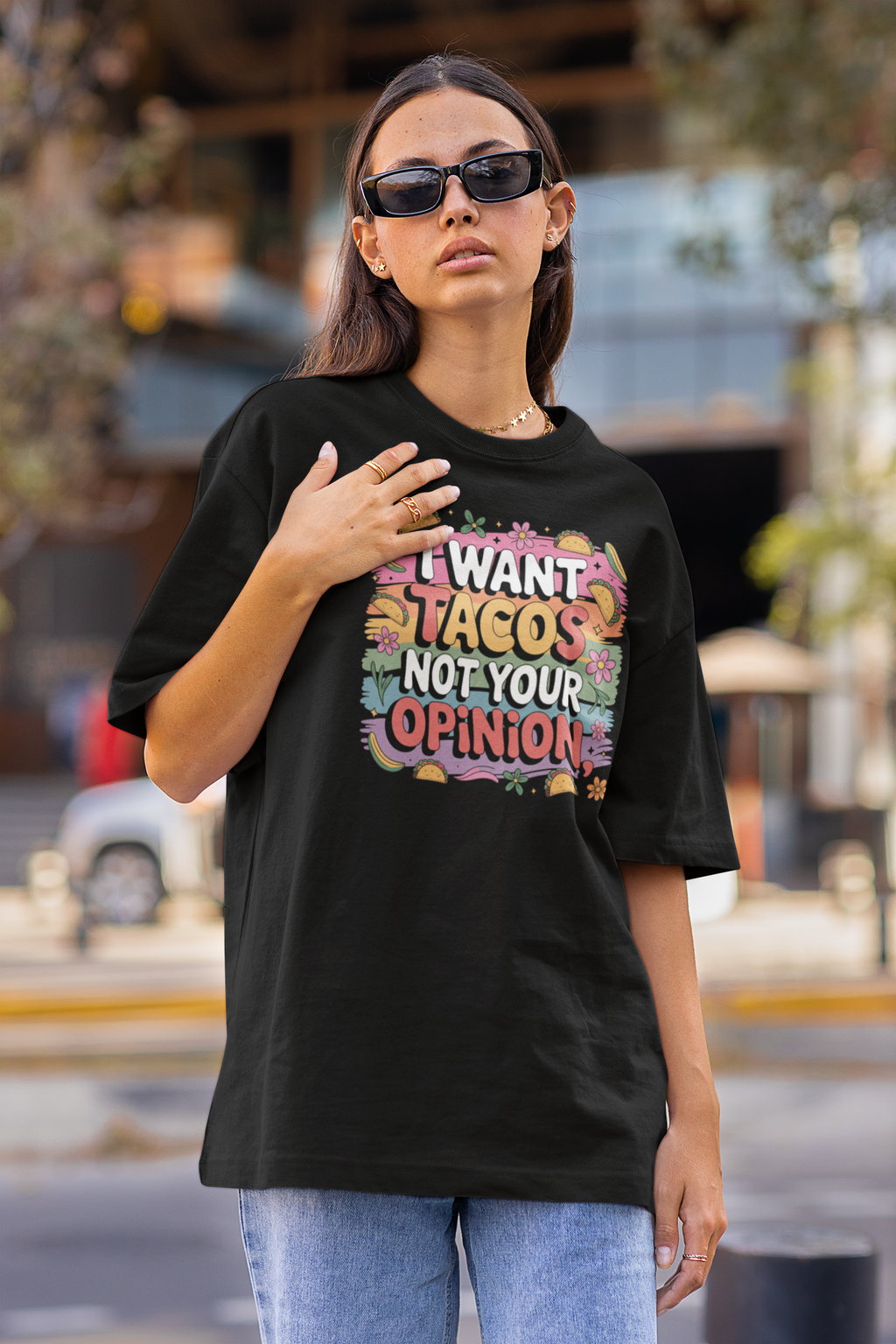 Woman wearing a black t-shirt with colorful text on a street background